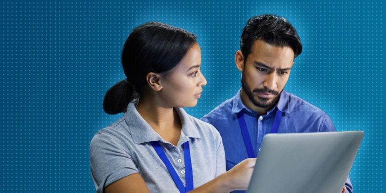 Woman pointing to laptop, showing male colleague screen