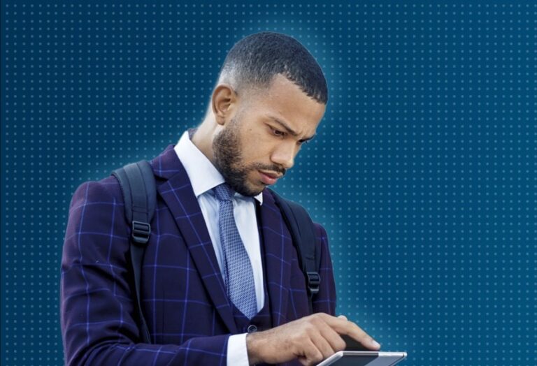 Man looking down at tablet, dark blue background with white dot overlay