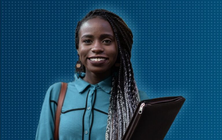 Woman smiling, holding a laptop wearing a backpack