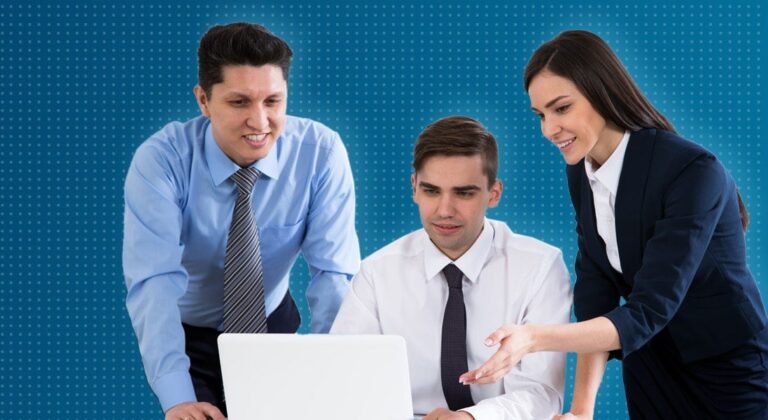 Three colleagues pointing to a laptop