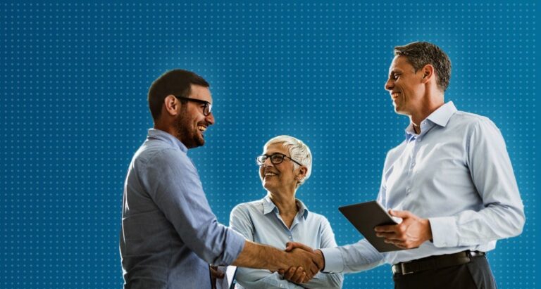 Two men shaking hands, woman smiling in background